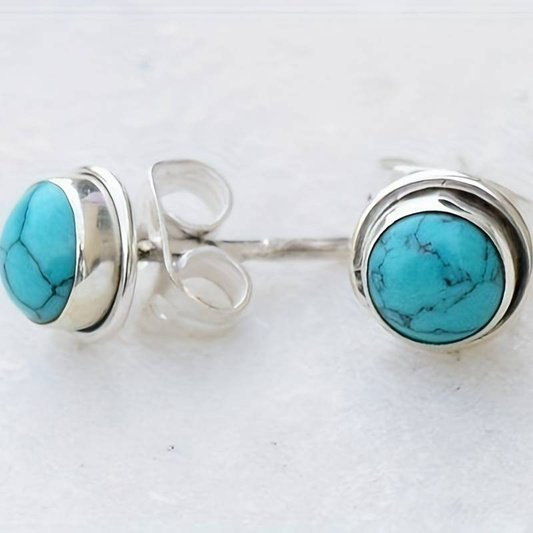 Elegante Vintage-Ohringe mit blauem Stein und silbernem Design